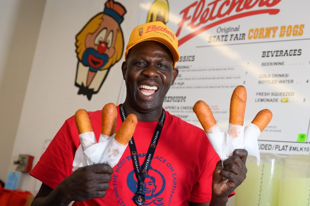 man holding Fletcher's corny dog at the State Fair of Texas