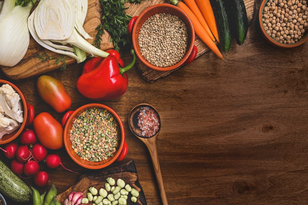 produce and seasonings spread out on wood table