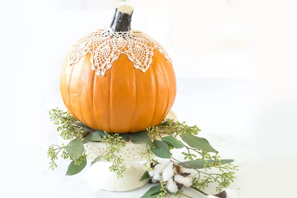 lace doilies used to decorate a pumpkin