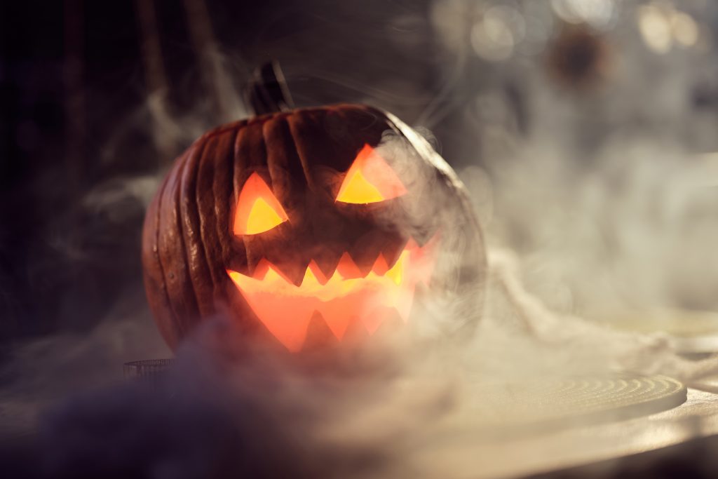 lit jack-o-lantern surrounded by fog