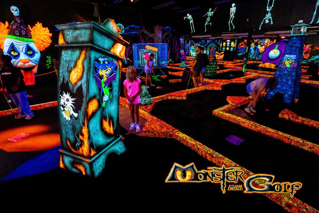 Monster Mini Golf course that's glowing in the dark.