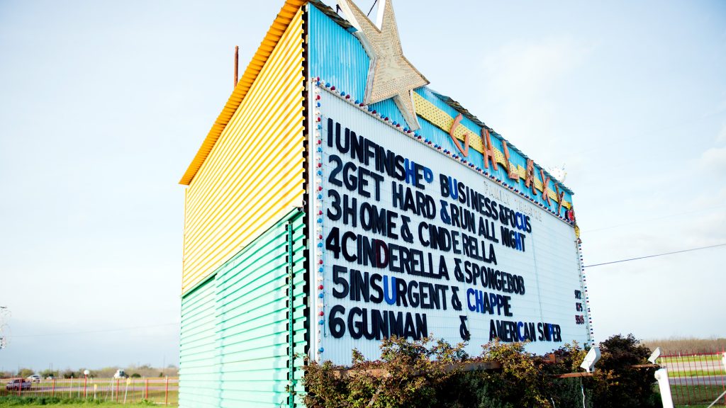 Large sign with list of movies showing at Galaxy drive-in theater