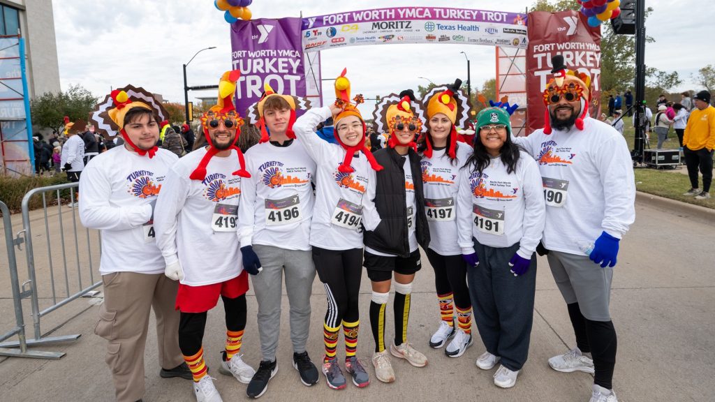 People wearing turkey hats after finishing a turkey trot.