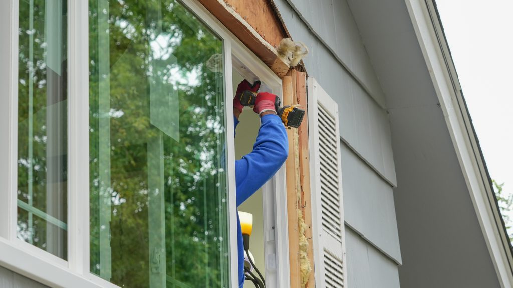 Person repairing home windows.