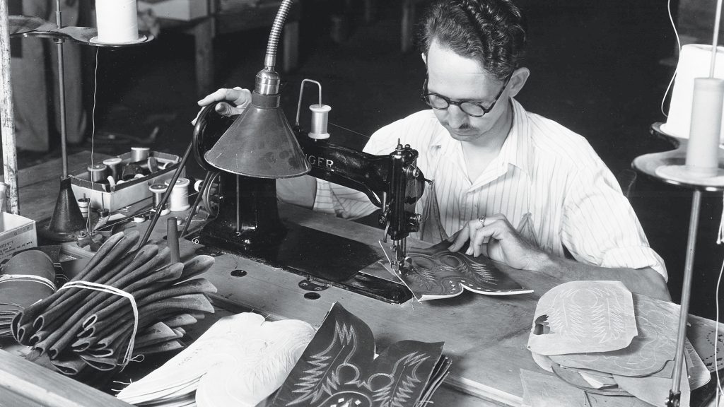 Old images of man making cowboy boots for Justin Brands Inc.