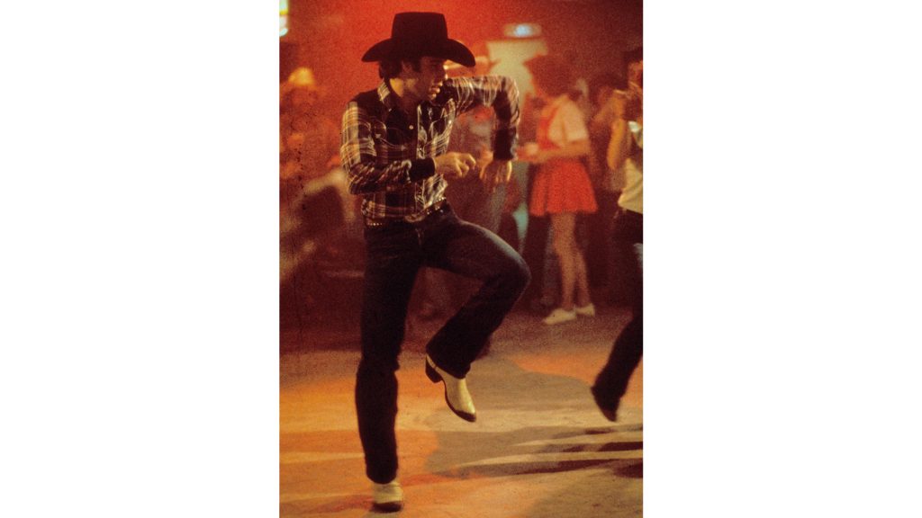 Man two-stepping in cowboy boots.