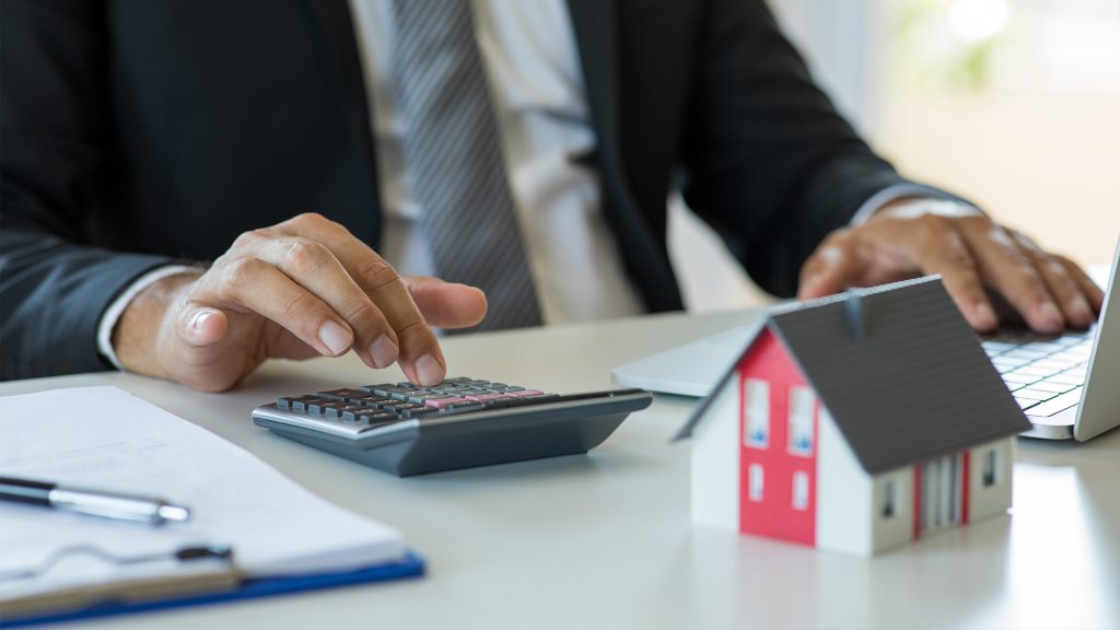 Person using a calculator at a desk.