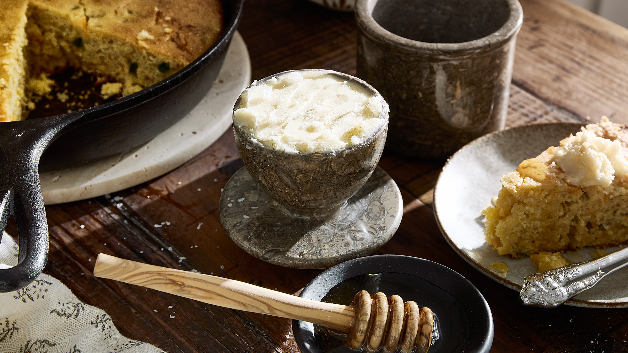 Mesquite honey butter next to a slice of cornbread.