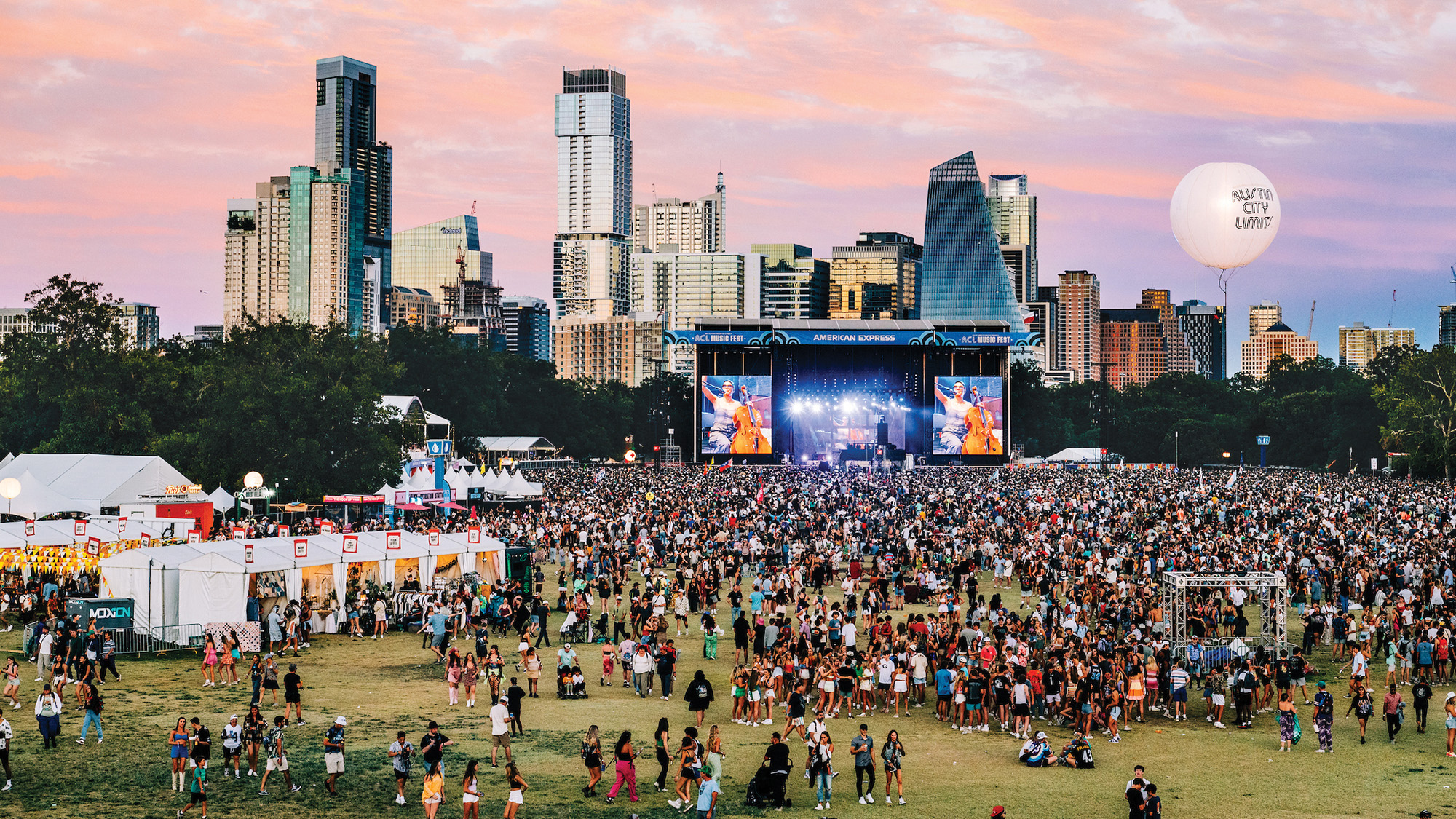 Aerial photo of Austin City Limits music festival with city of Austin in the background.