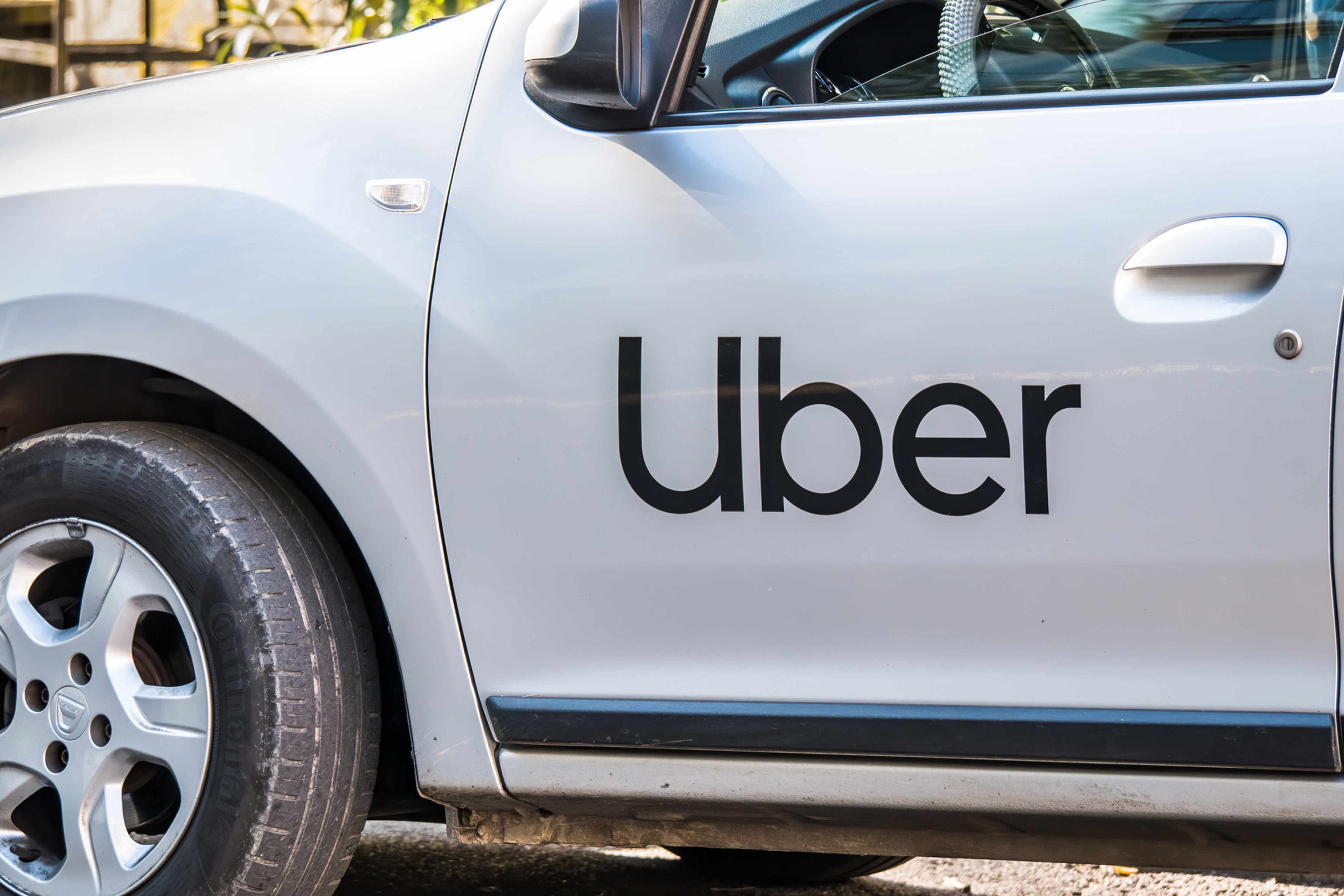 Car with Uber sign on door.