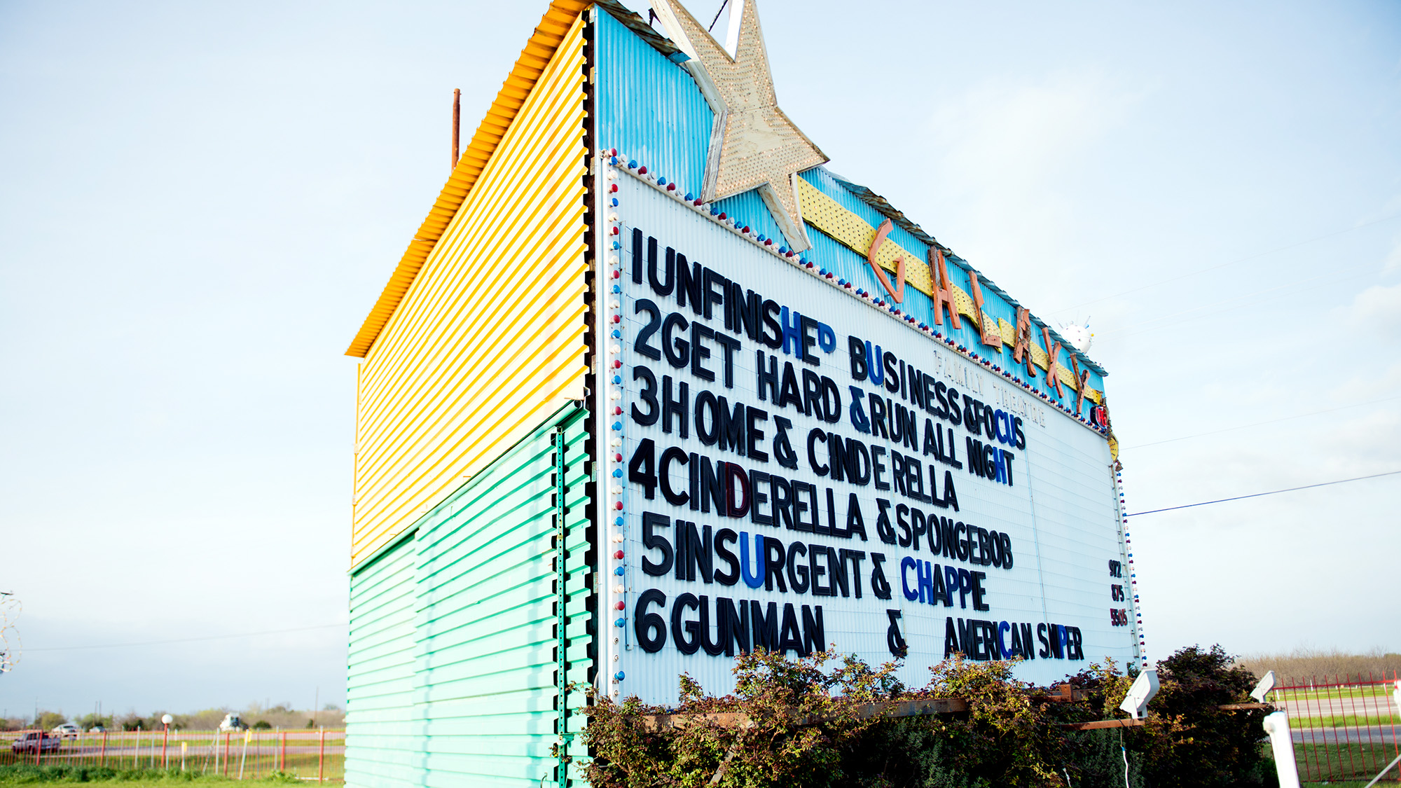 Large sign with list of movies showing at Galaxy drive-in theater
