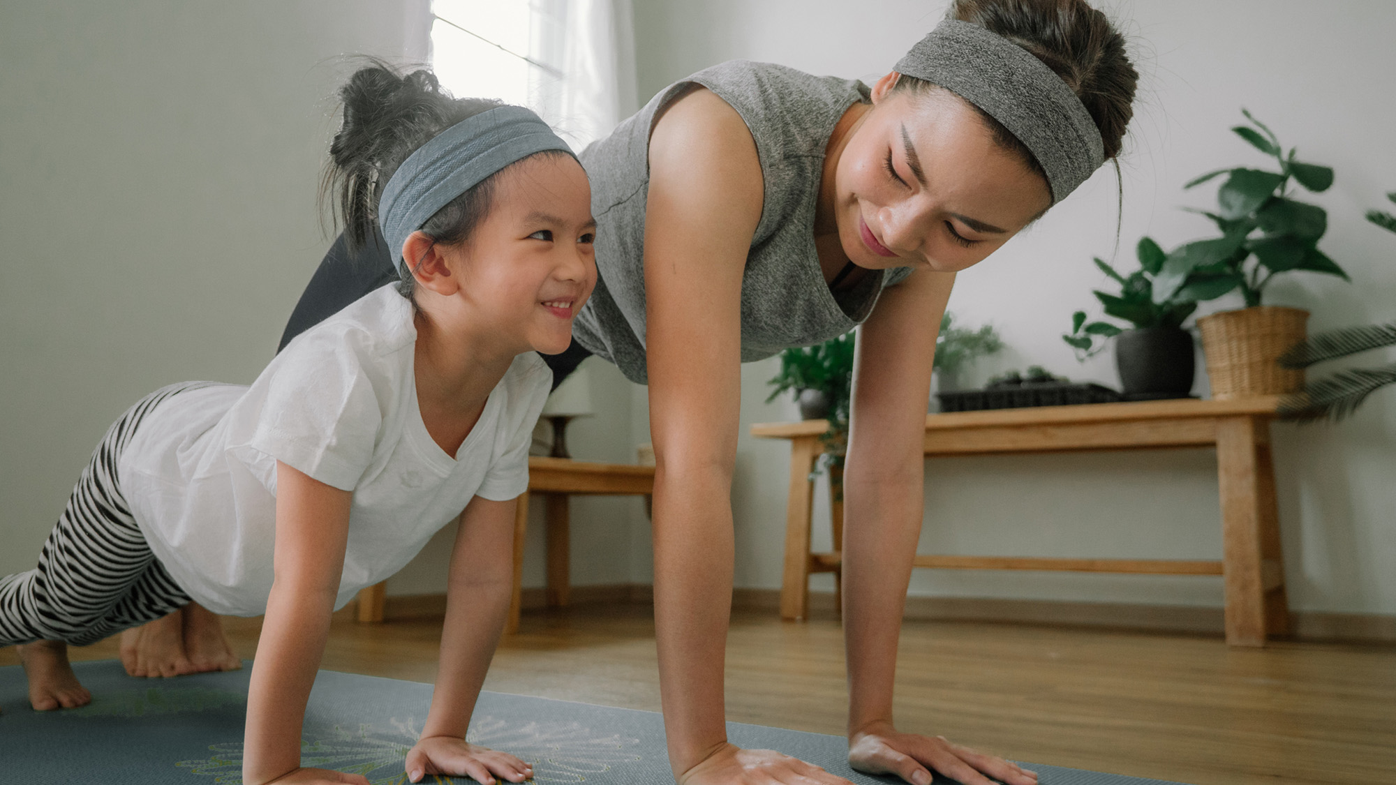 Mom and kid doing yoga.