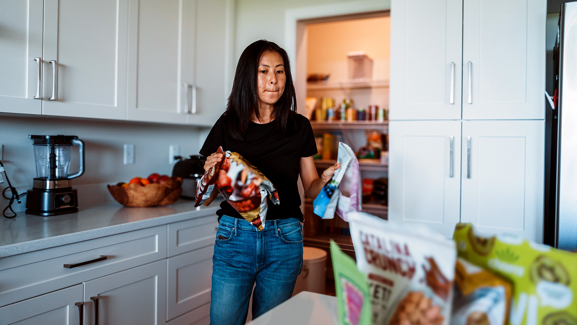 Person taking snacks out of pantry.