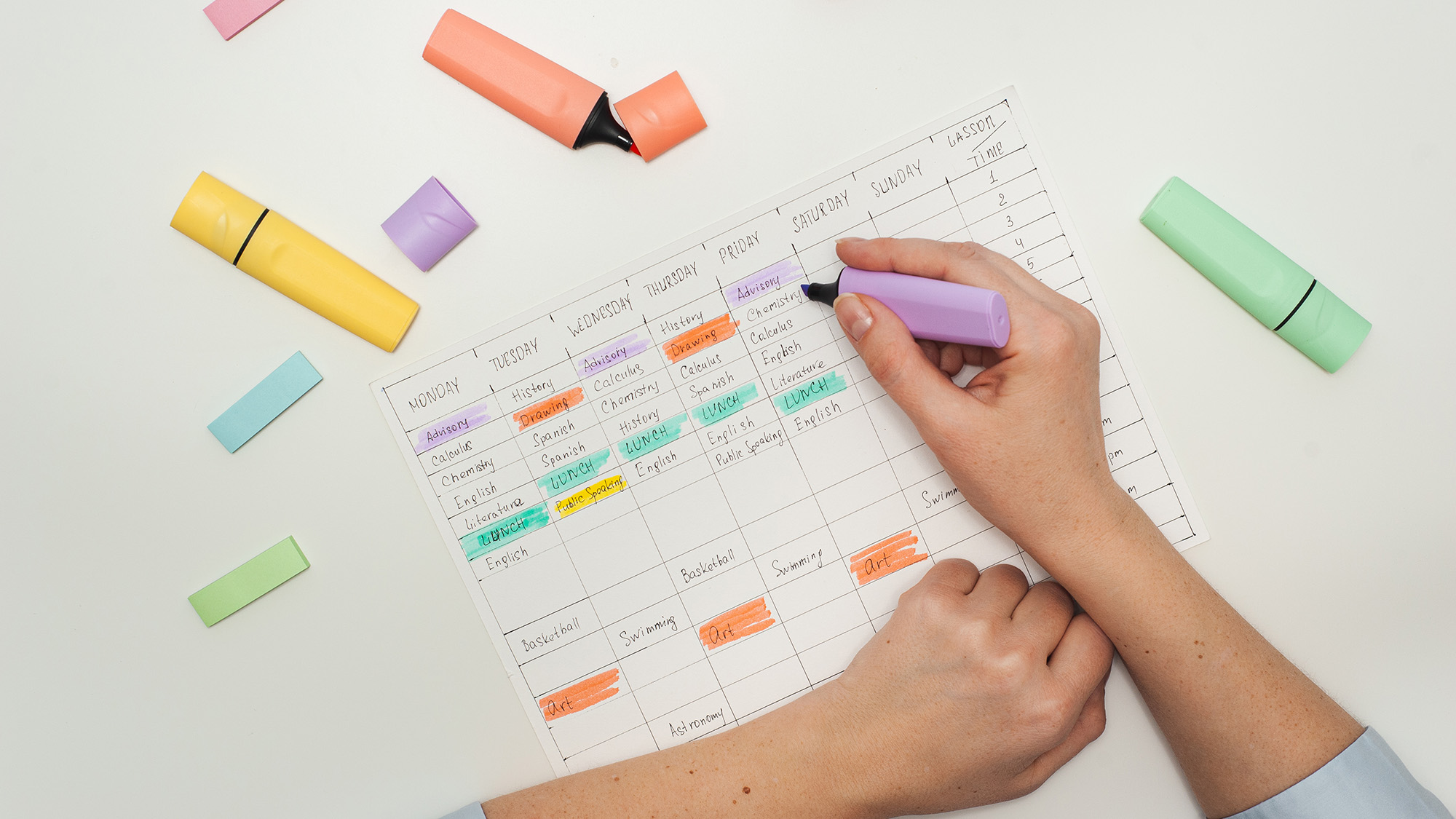 Person color-coding a calendar.