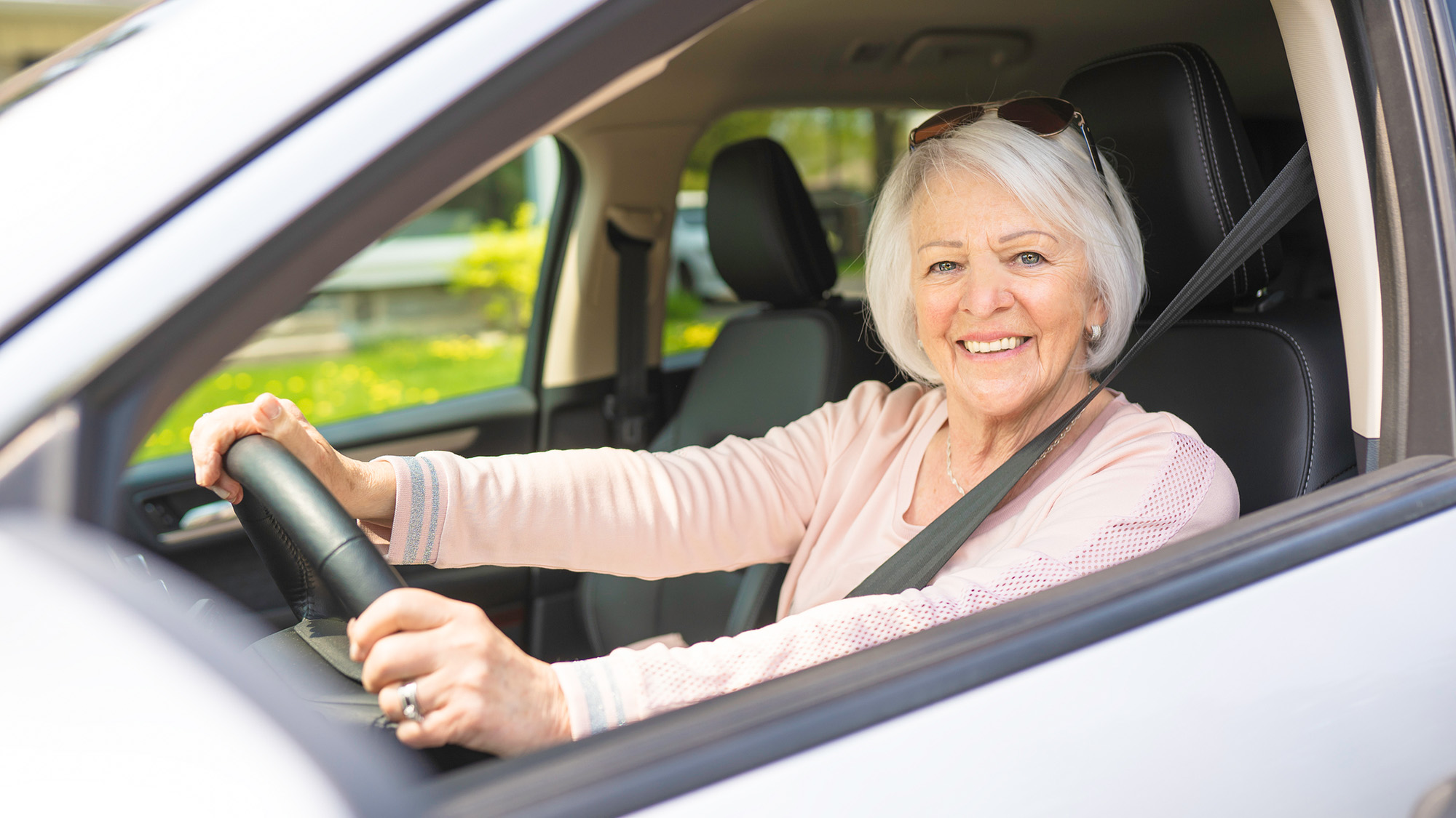 Older woman driving a car.