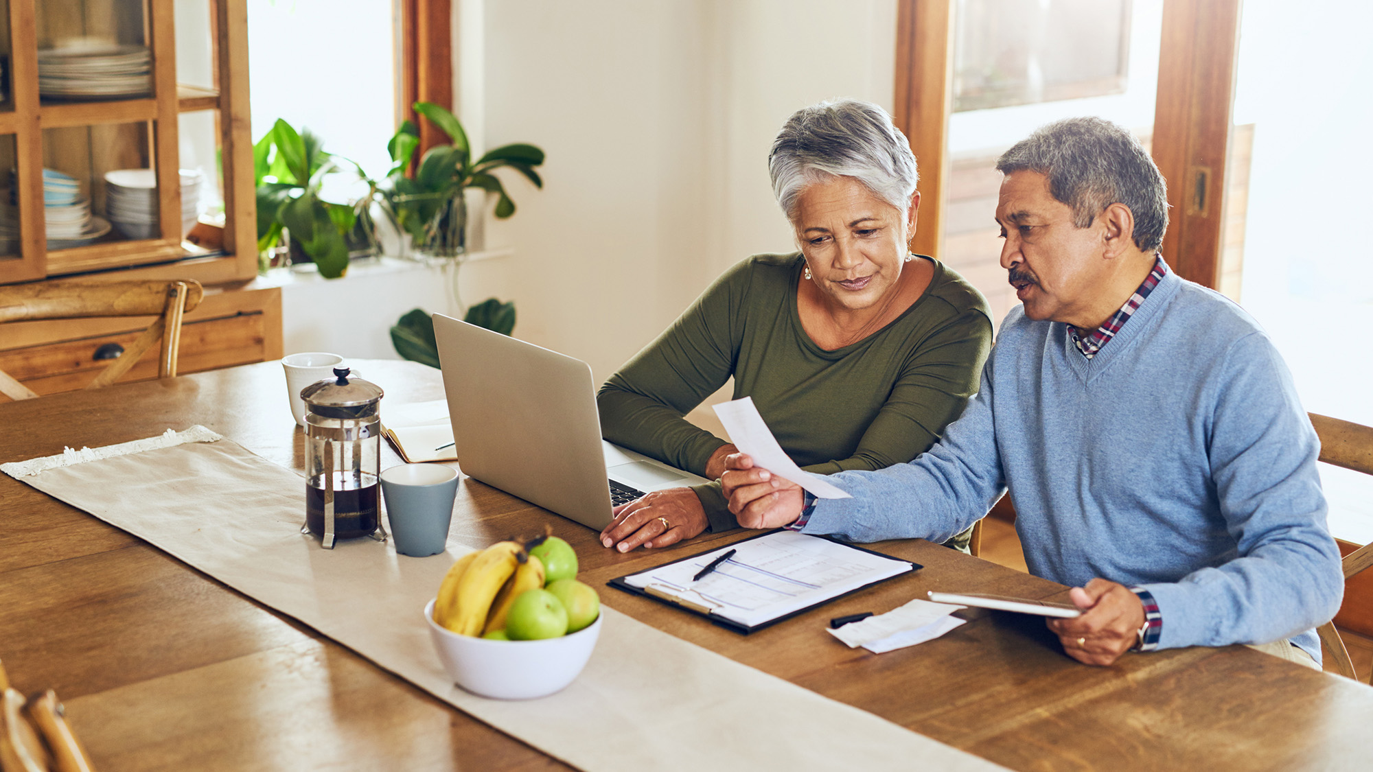 Man and woman reviewing documents at a desk.