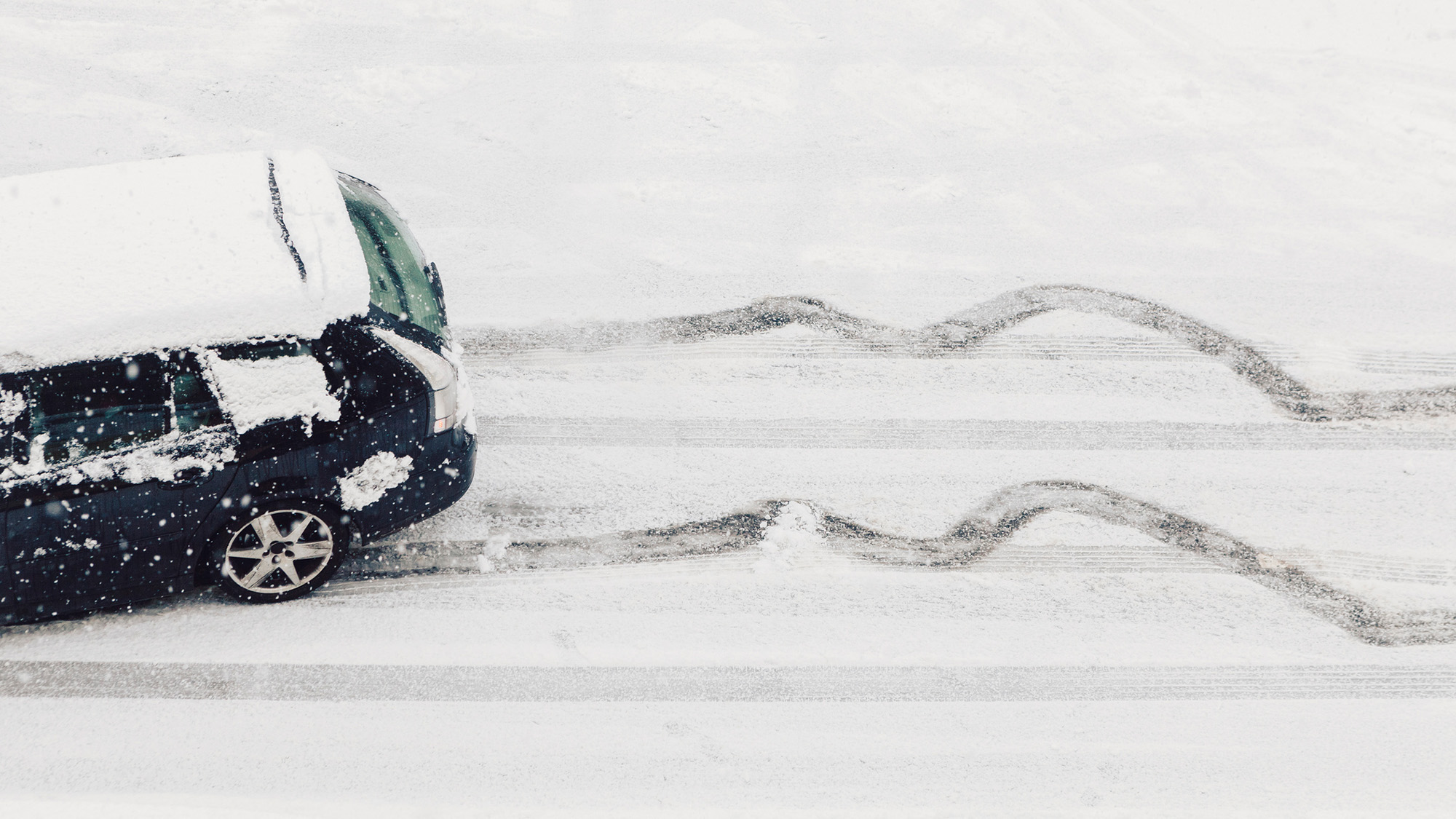 Car drifting on snowy road.