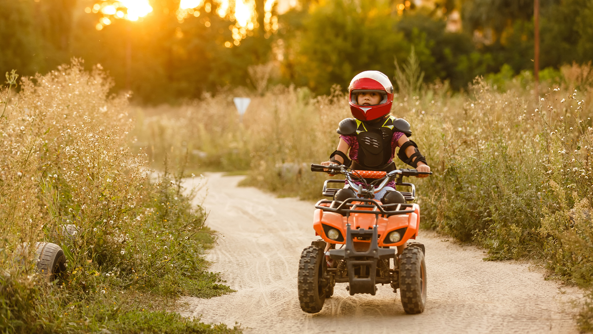 A kid riding an ATV.