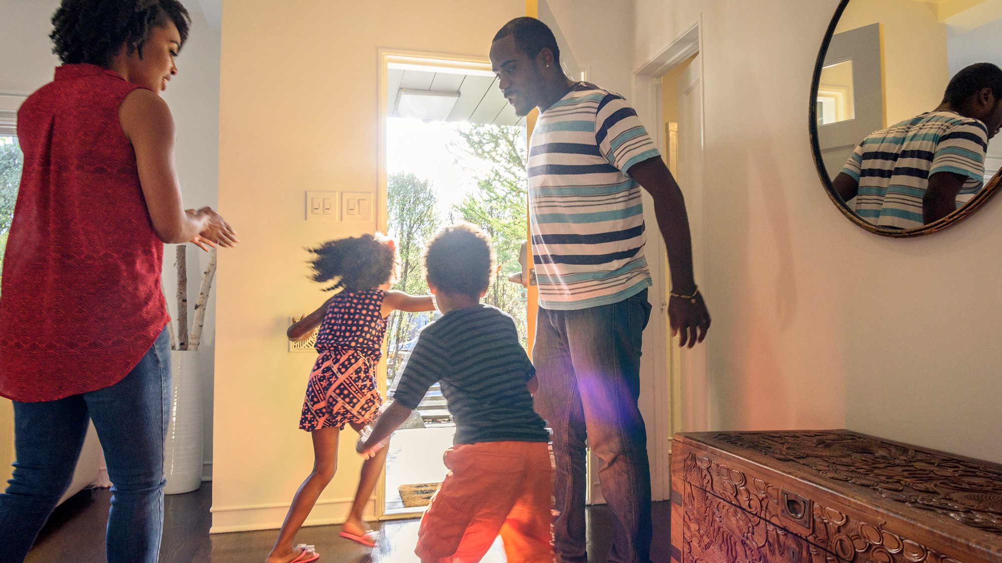 Family of four running out the front door.