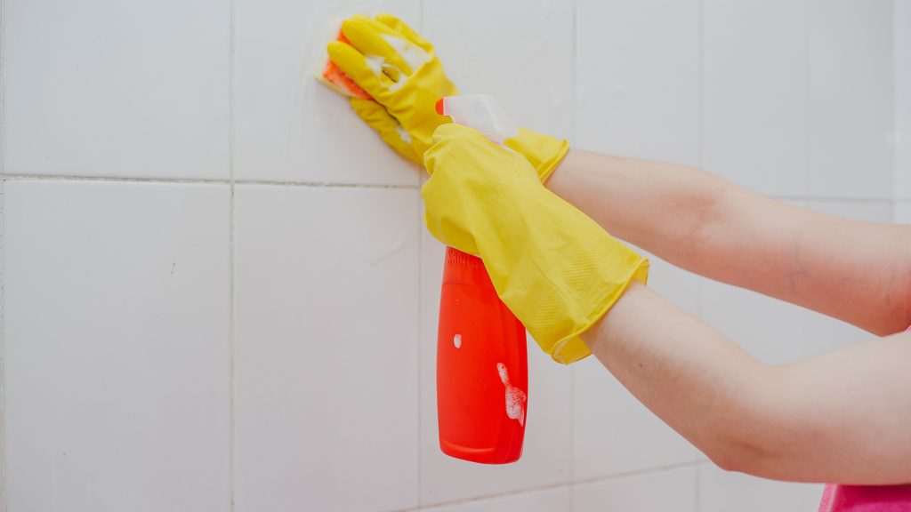 Person cleaning grout.