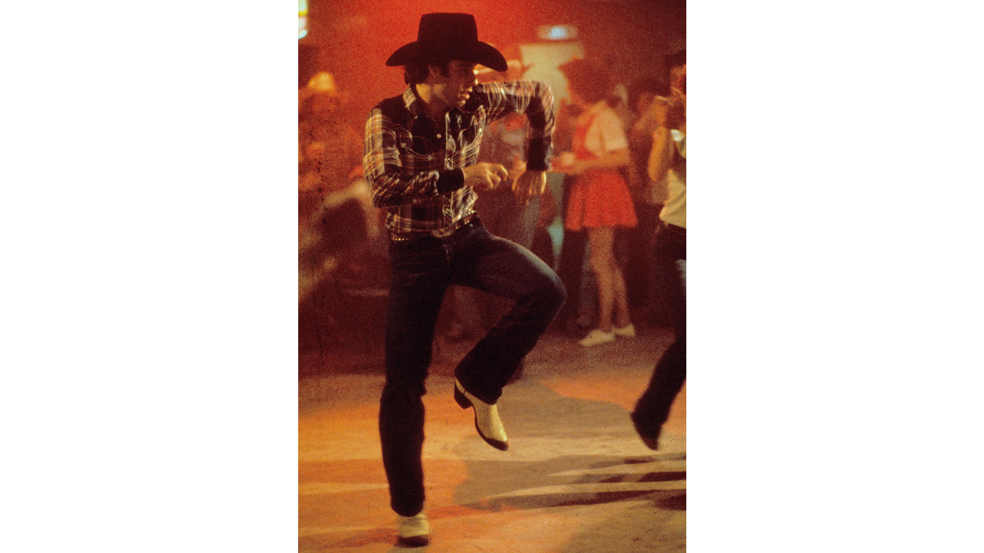 Man two-stepping in cowboy boots.