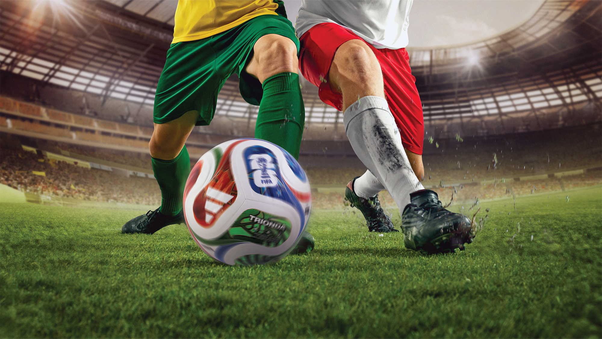 Two soccer players kicking a soccer ball.