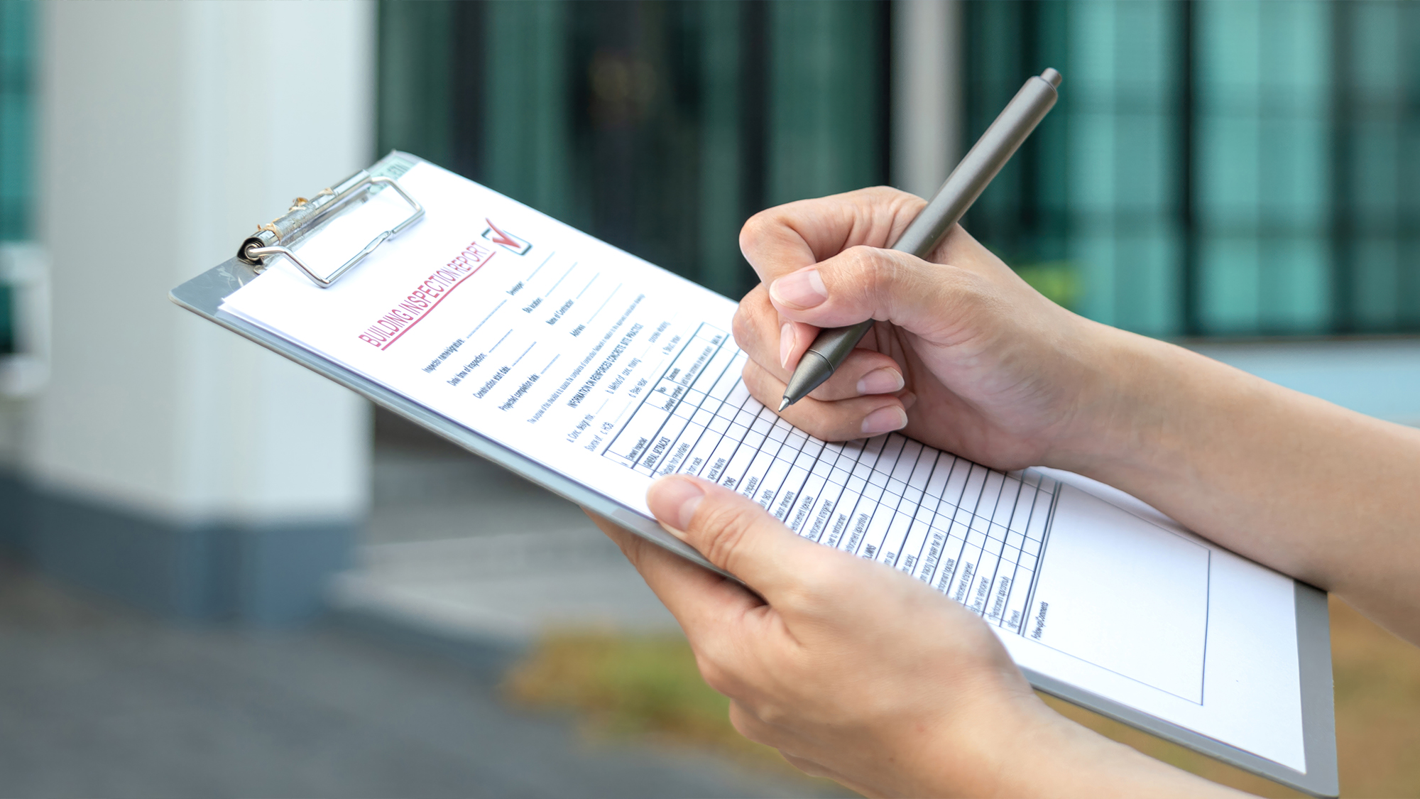 Person checking information on a clipboard.