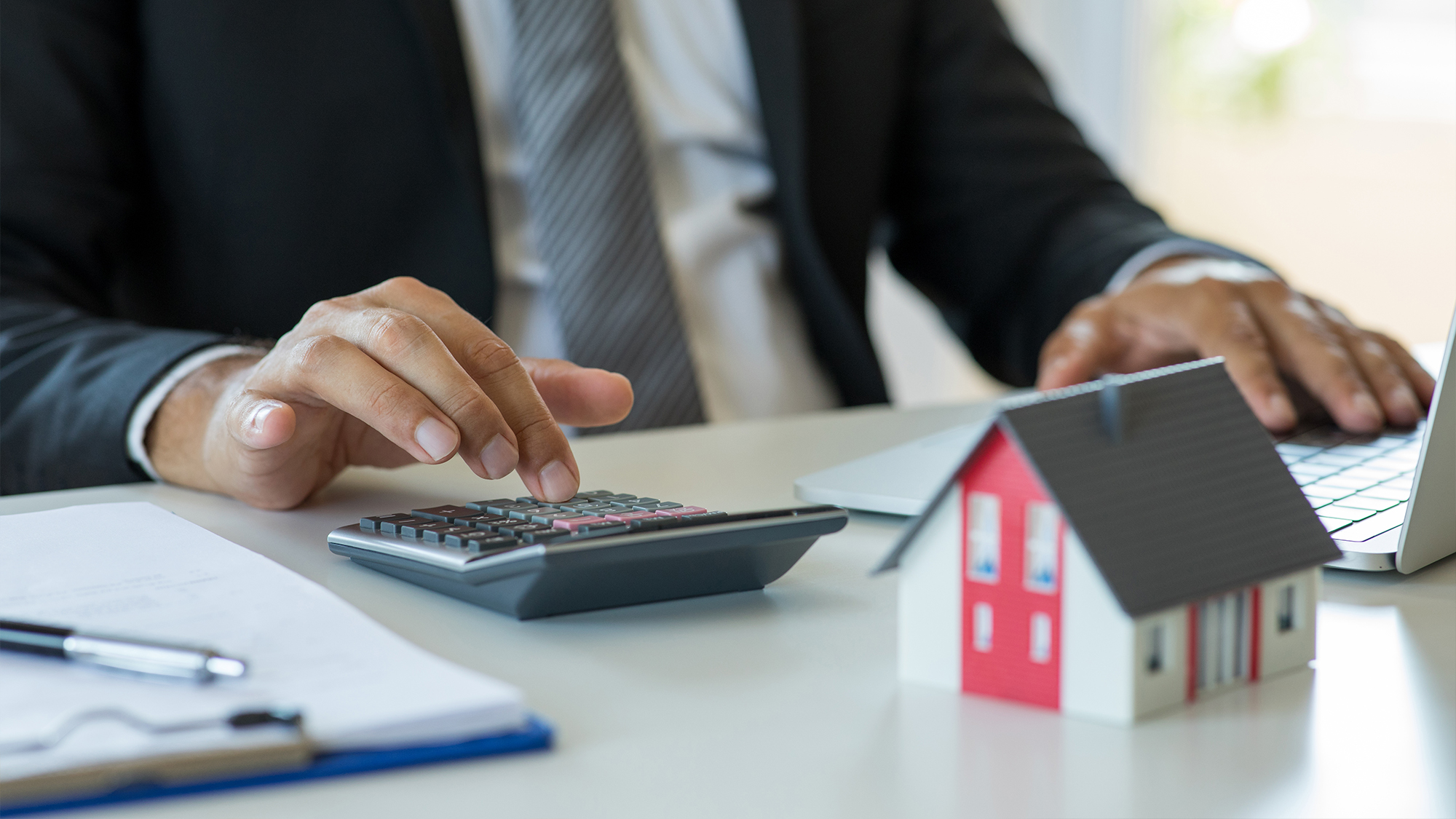 Person using a calculator at a desk.