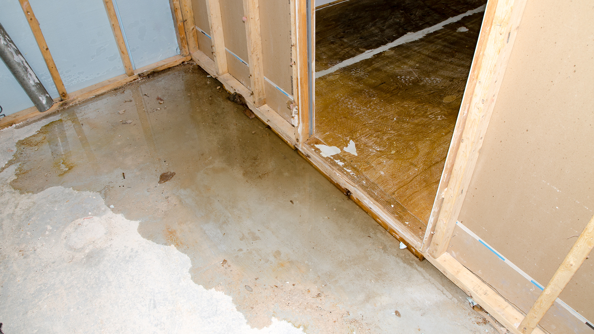 Water leaking on a house foundation.