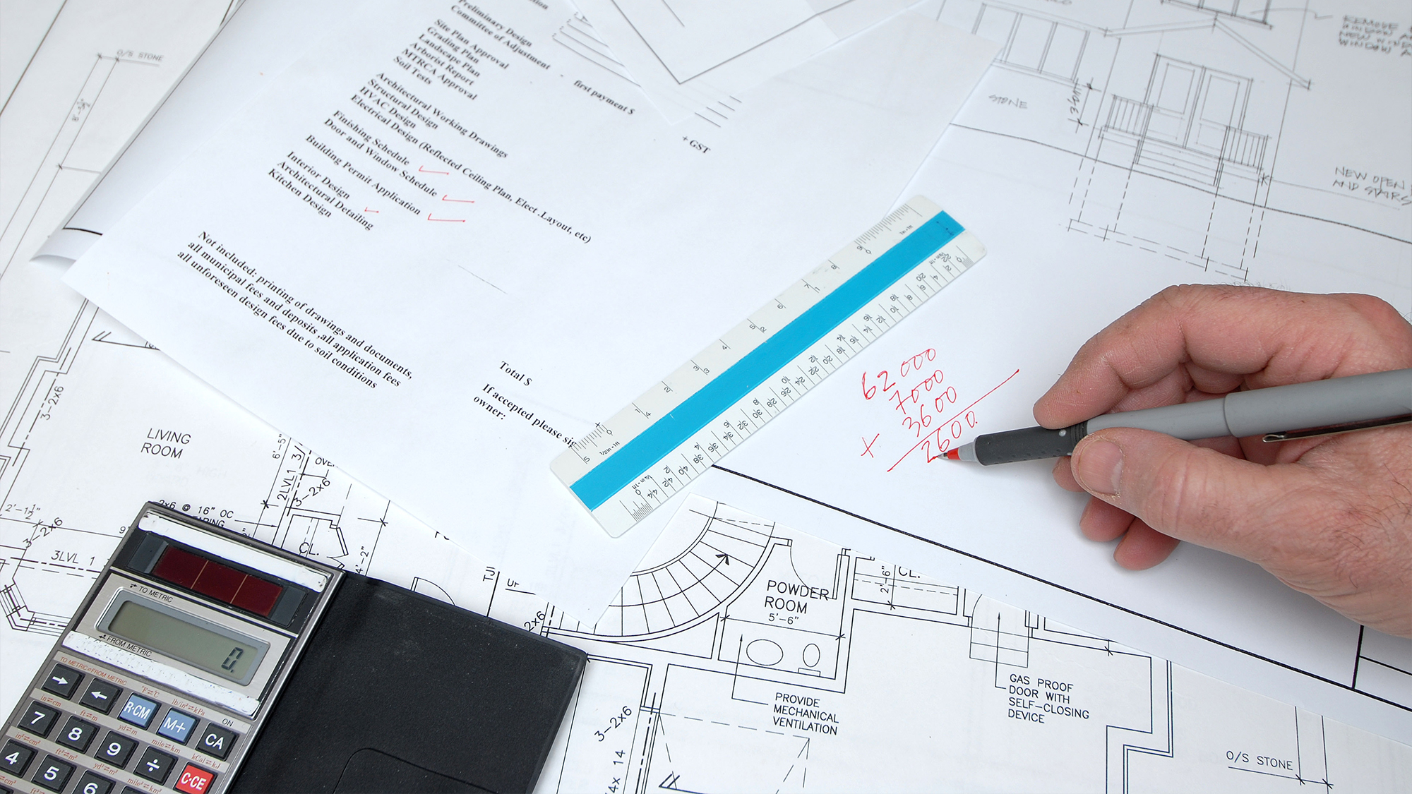Person running calculations on home renovations.