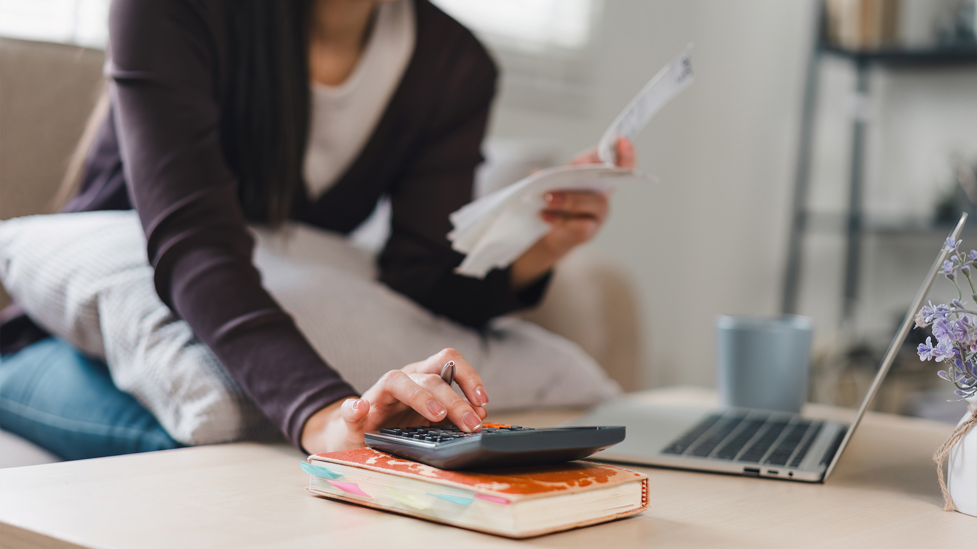 Person using calculator at desk.