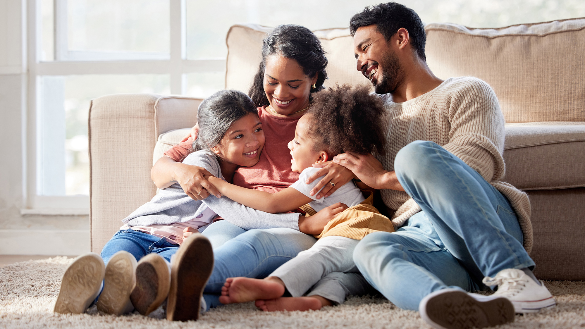 Family hugging in living room.