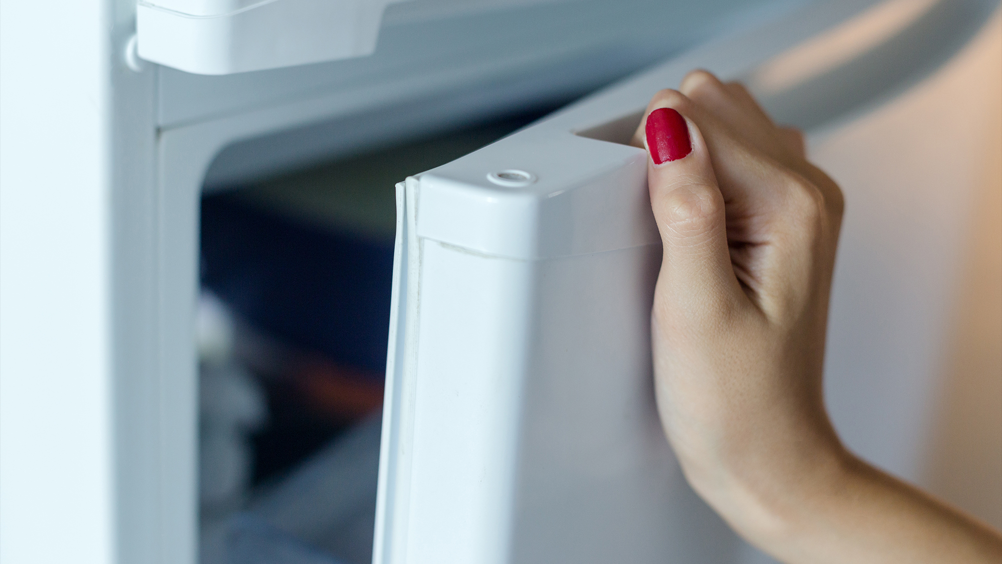 Person opening fridge door.
