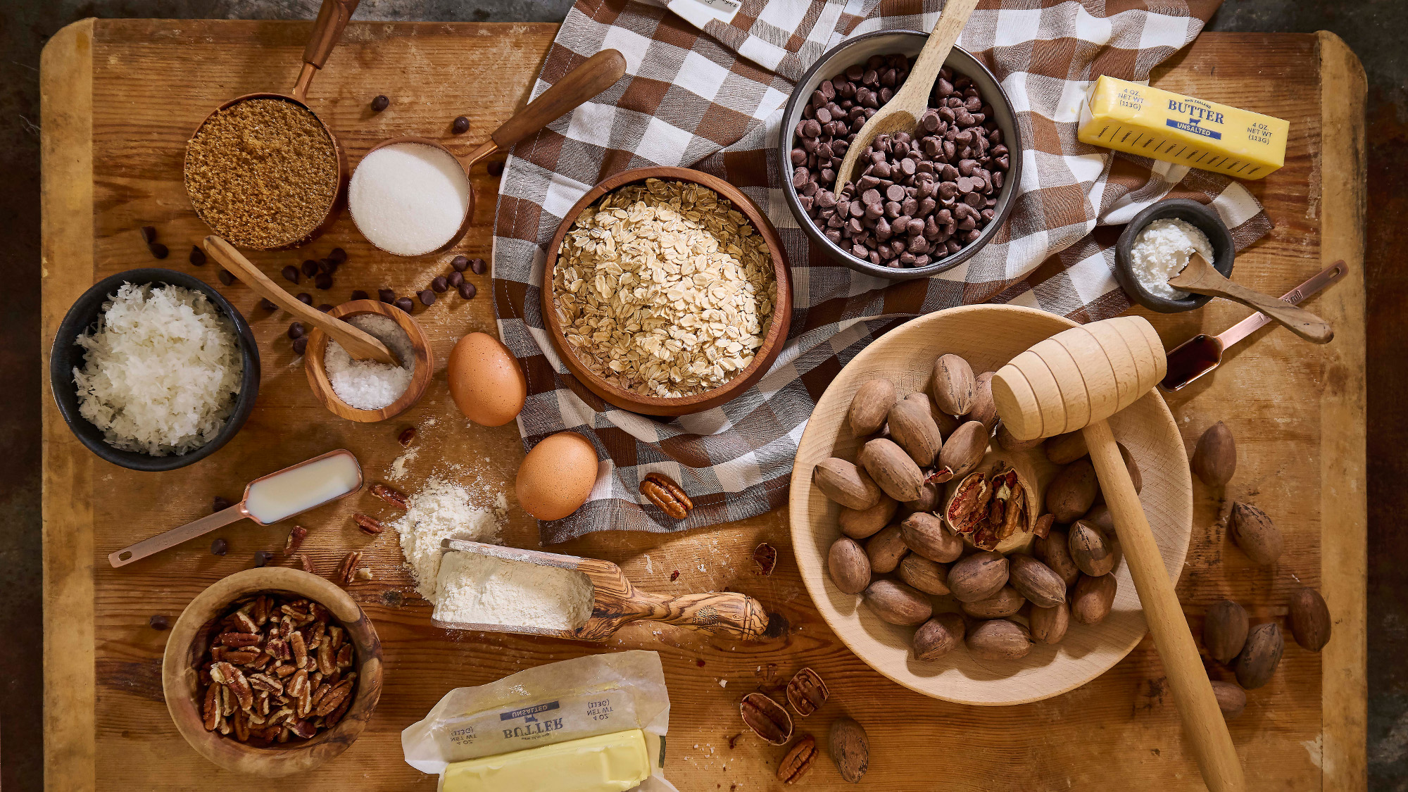 Ingredients to make cowboy cookies on a cutting board.