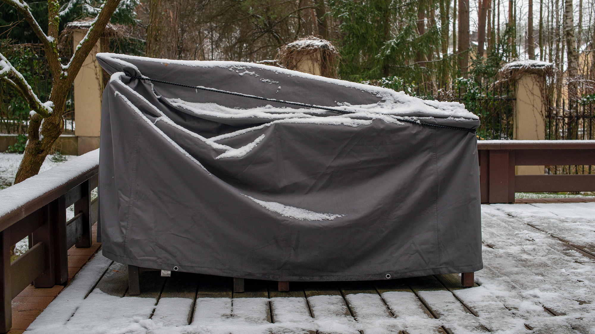 Outdoor furniture with a cover to keep snow off it.