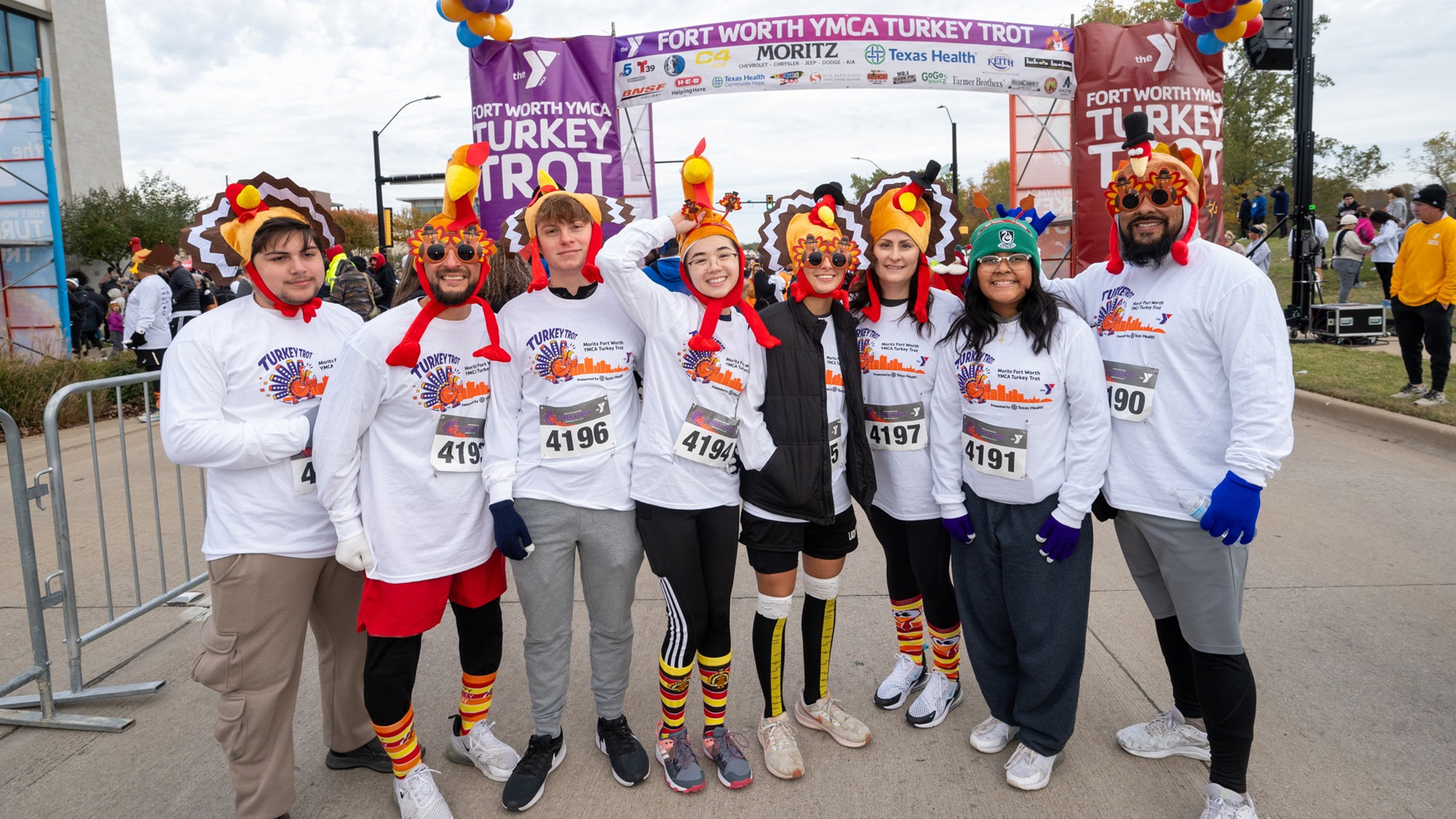 People wearing turkey hats after finishing a turkey trot.