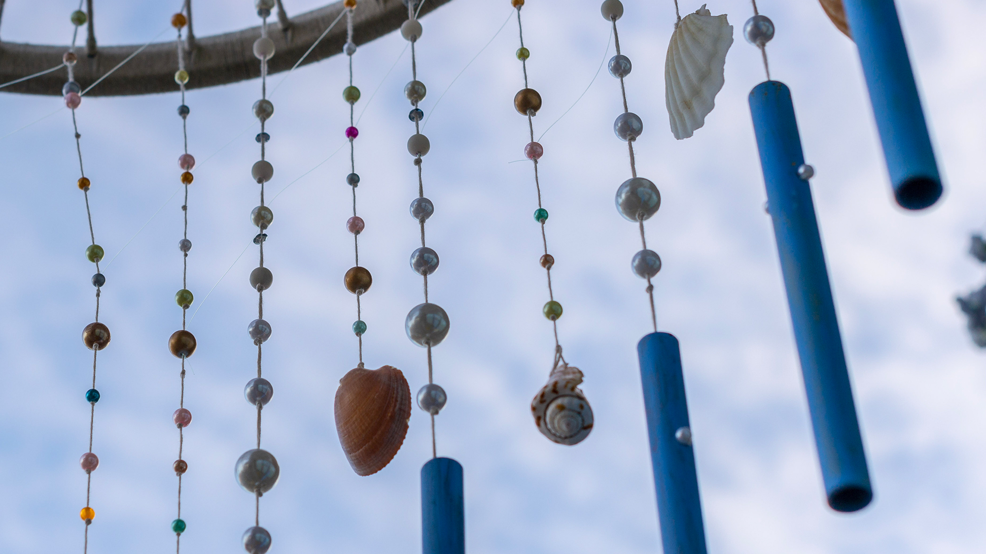Wind chime made from beads and shells.