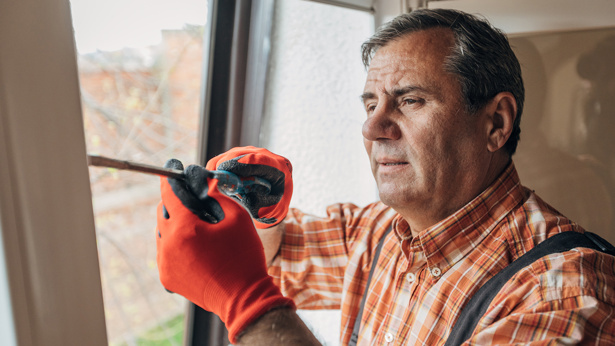 Man caulking windows.
