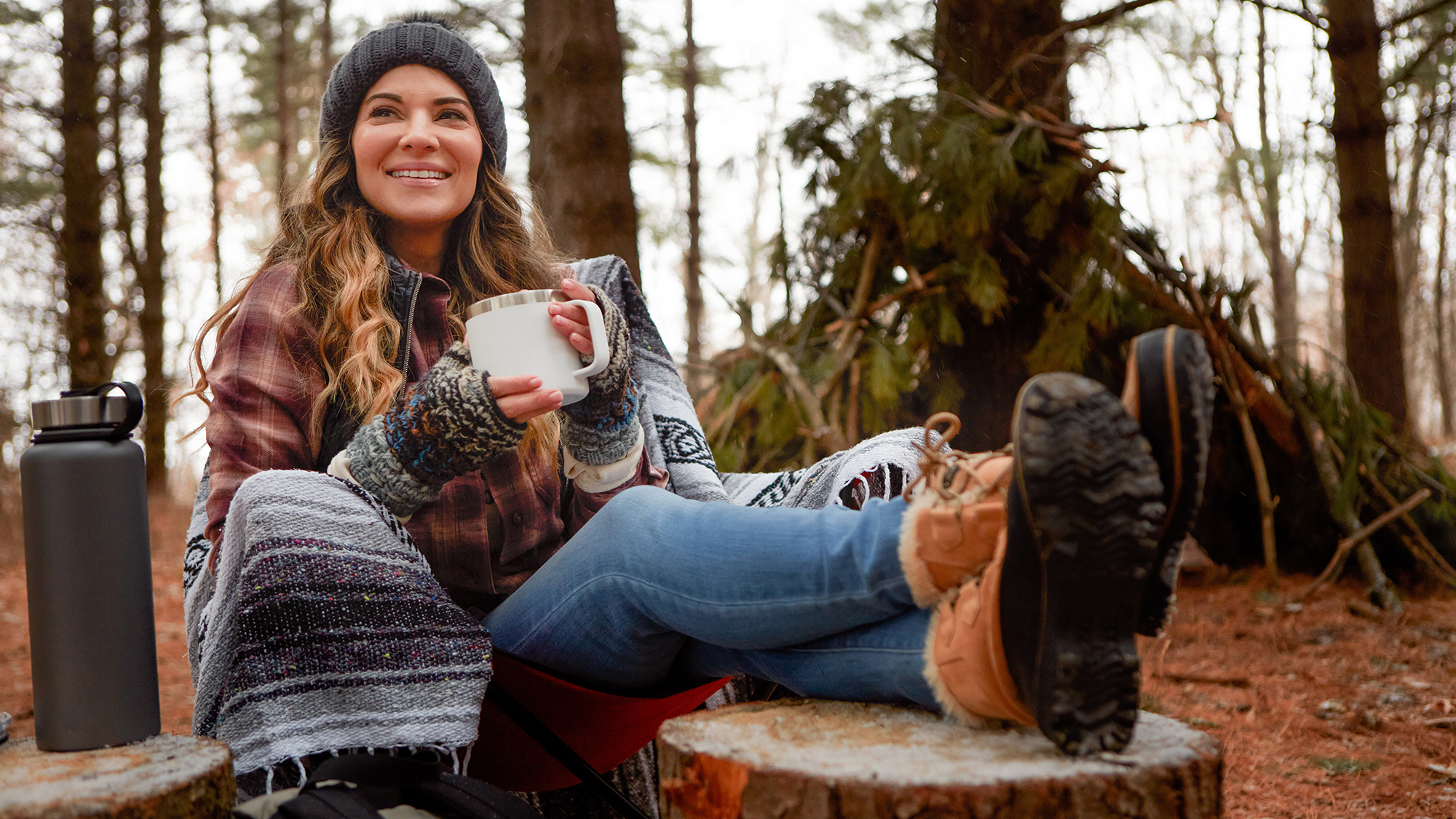 Woman reclining at a campsite.