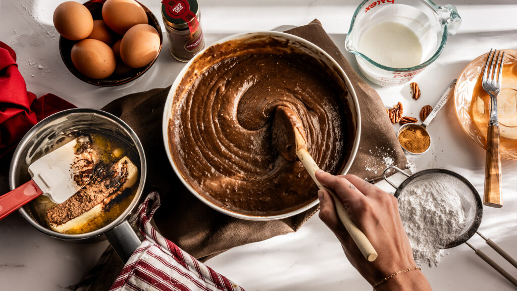 Person making Texas sheet cake.