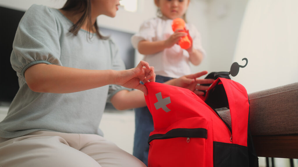 Person putting together emergency go bag.
