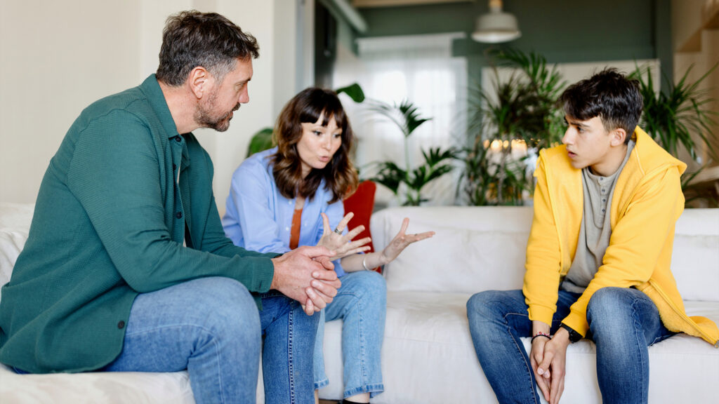Parents talking with a younger adult.