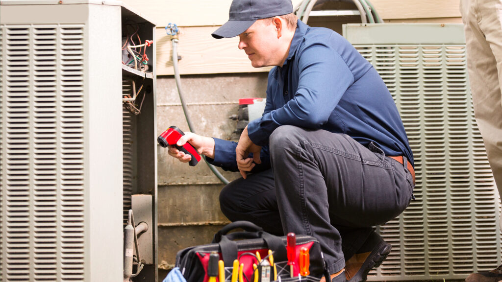 Person doing maintenance on HVAC unit.