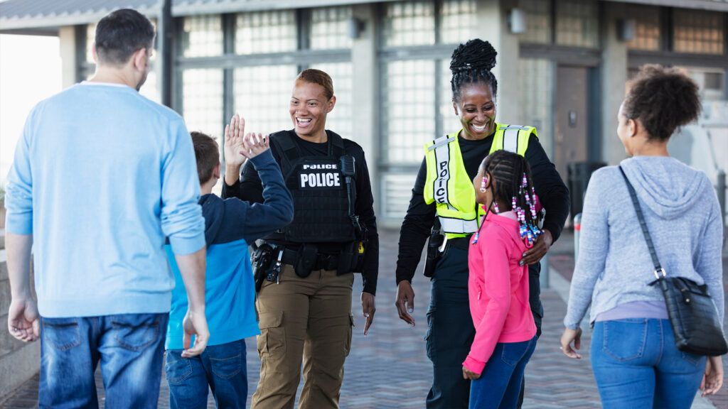 Police officers meeting a family.