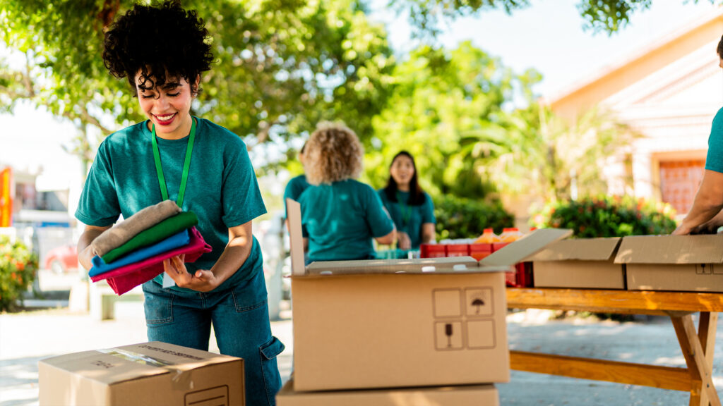 Volunteers packing supplies in boxes.