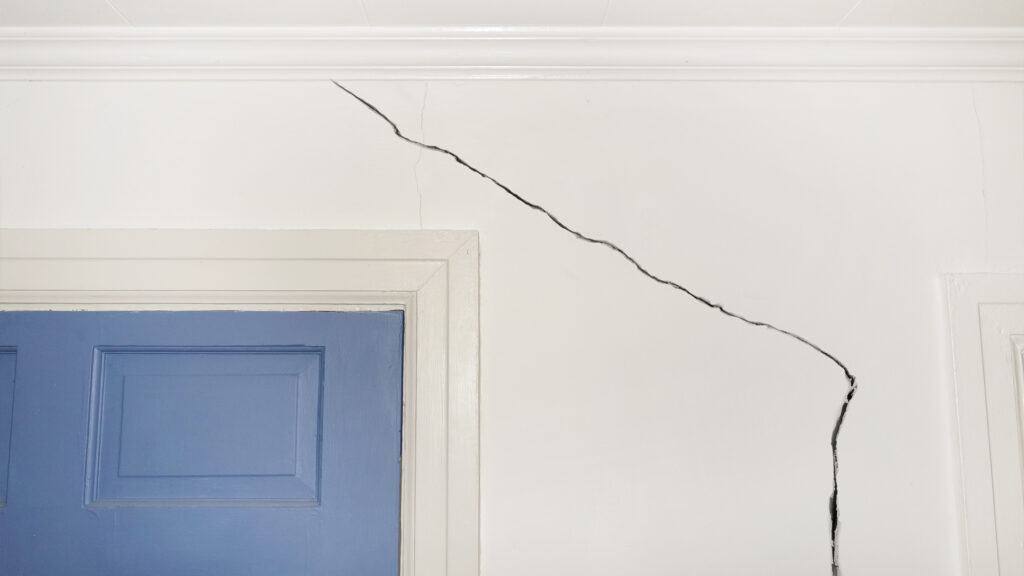Cracked wall around door frame.