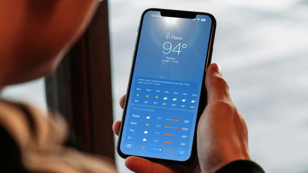 Person looking at weather app on phone.