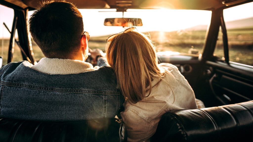 Two people driving in a car.