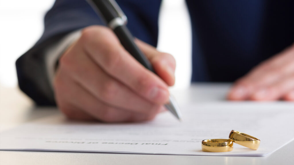 Person signing paperwork.