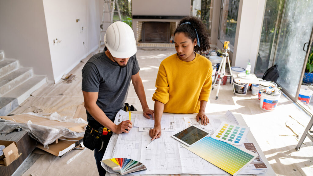 People reviewing building paperwork.